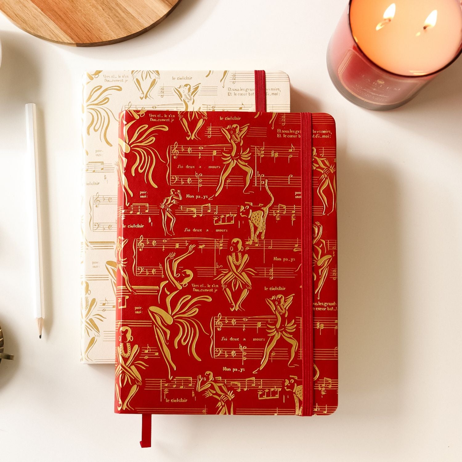 This is a lifestyle image of our Ode to Josephine journals in red and cream with gold design.