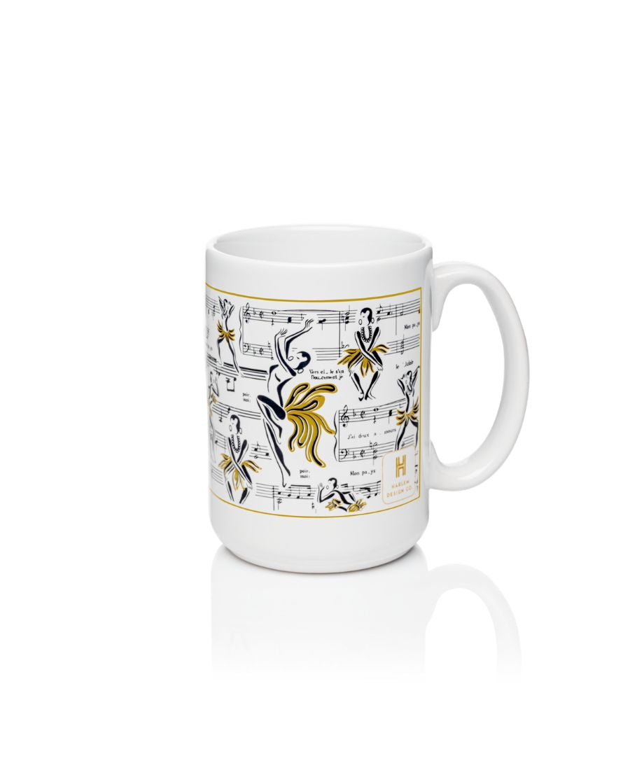 White mug with illustrations of Josephine Baker dance with her music notes in the background. White mug with black and gold art.