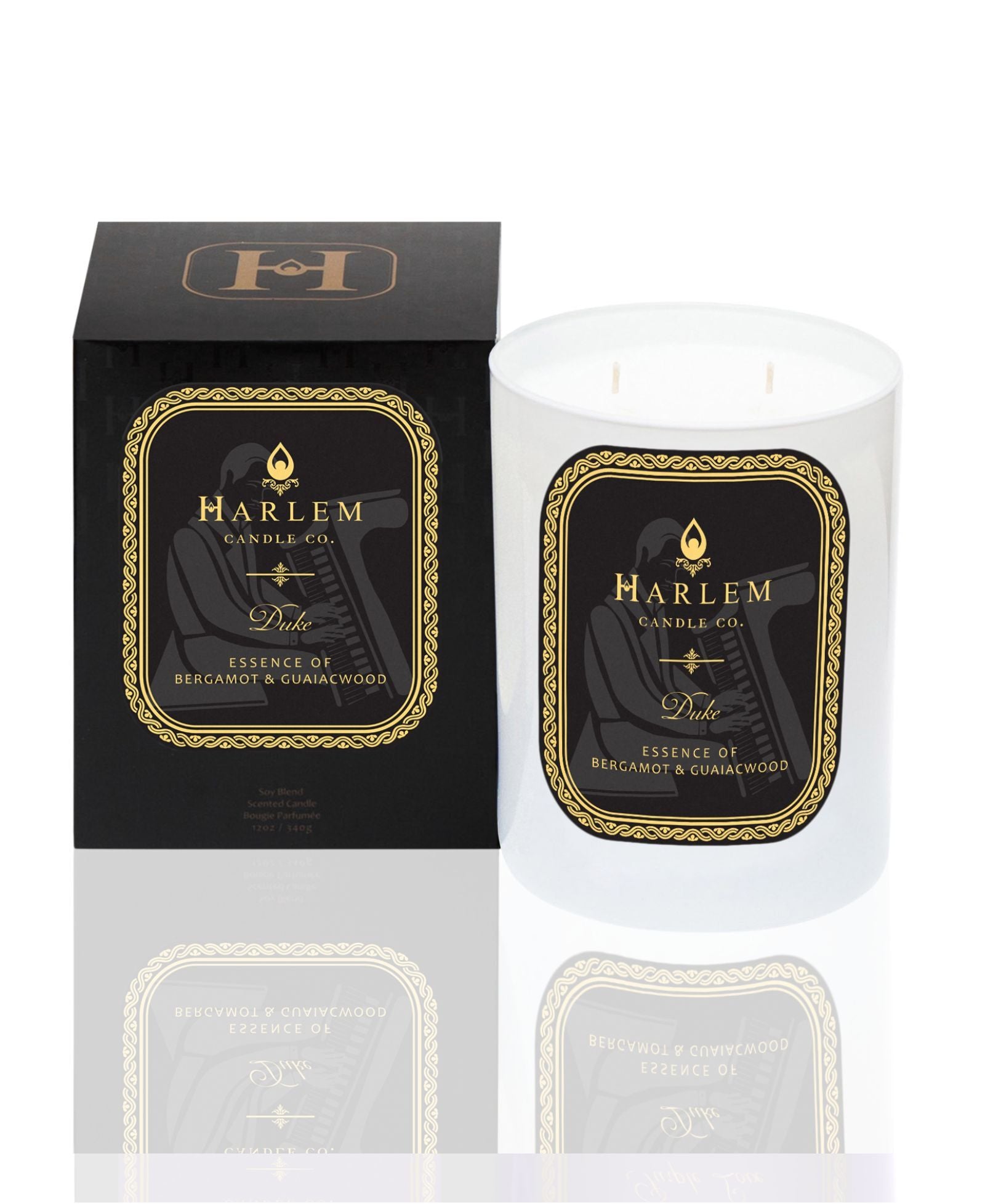 White 11 oz Duke candle with gold and Black label. This candle has 2 wick.  It is pictured next to it's decorative candle box.