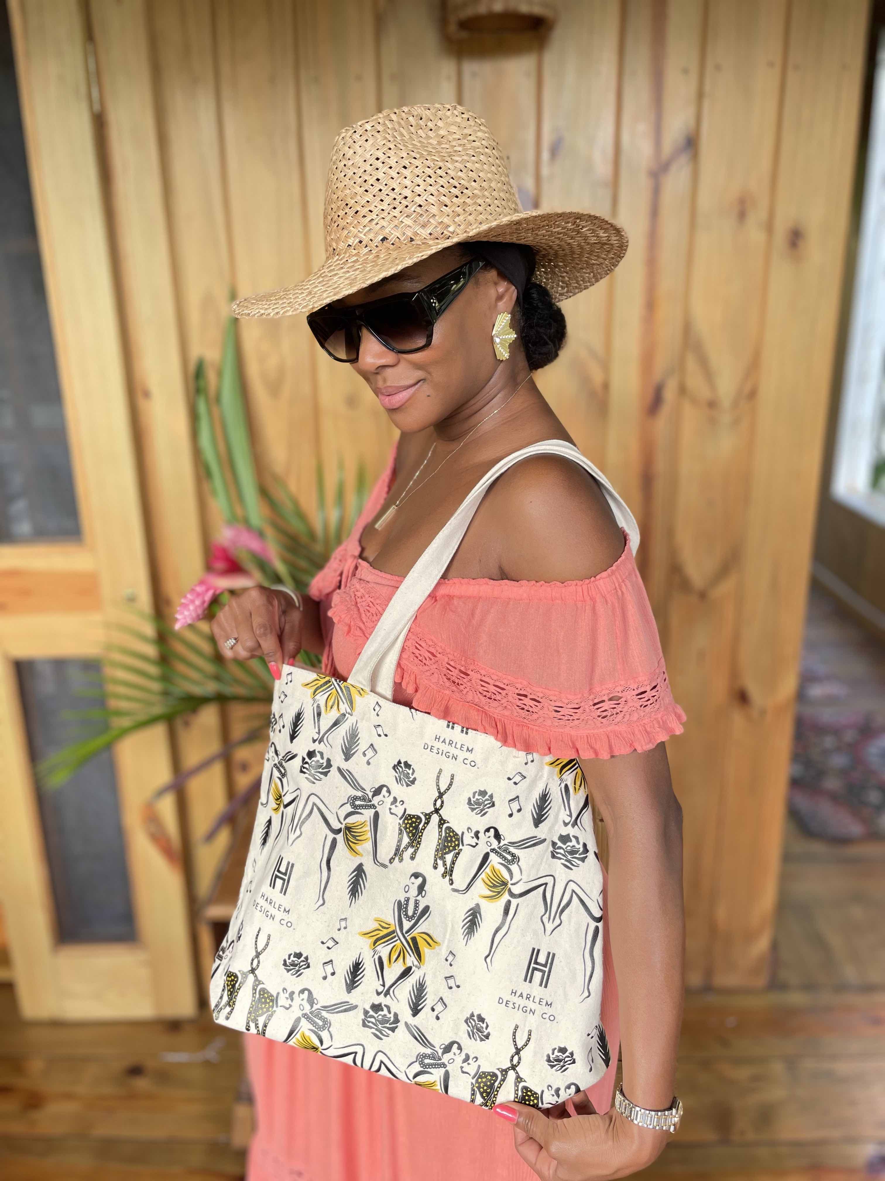 This is an image of founder, Teri Johnson showing the Harlem design company tote bag